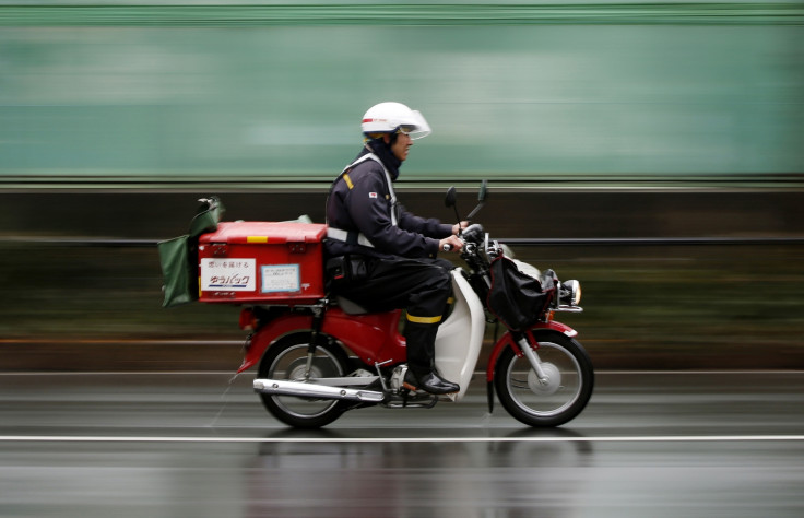 A postman of Japan Post rides a motorcycle in Tokyo