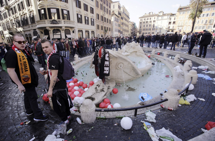 Feyenoord fans stand next to the fountain called