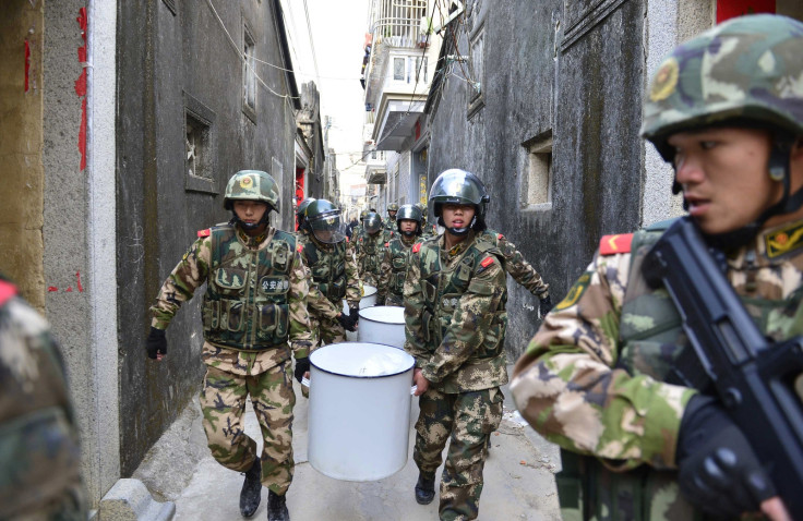 Paramilitary policemen carry seized crystal meth at Boshe village, Lufeng, Guangdong province, in December 2013. (Reuters)