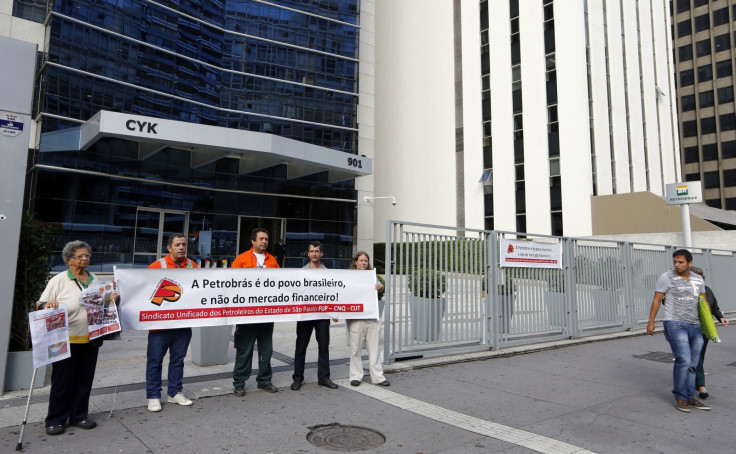 Petrobras' workers hold a banner in front of the Petrobras headquarters in Sao Paulo February 6, 2015.