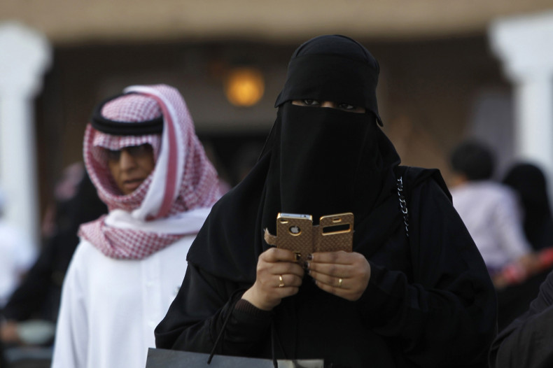 A woman using an iPhone visits the 27th Janadriya festival on the outskirts of Riyadh in this February 13, 2012 file photo.