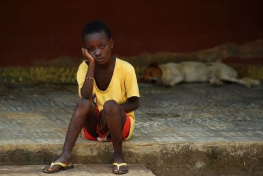 A child under quarantine sits outside a care center in Lokomasama, in the Port Loko province which has been severelly hit by the Ebola.