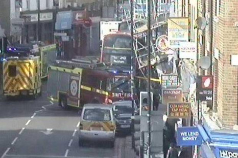 Scaffolding lies against bus in Peckham Road
