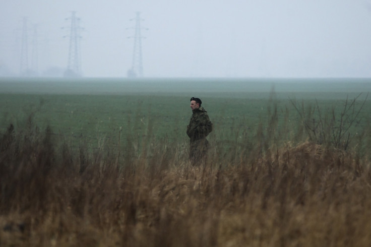 Serbian soldier stands at a crash site