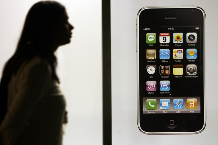 Woman walks past Swisscom store before joining queue to buy Apple's iPhone 3G after it went on sale in Zurich