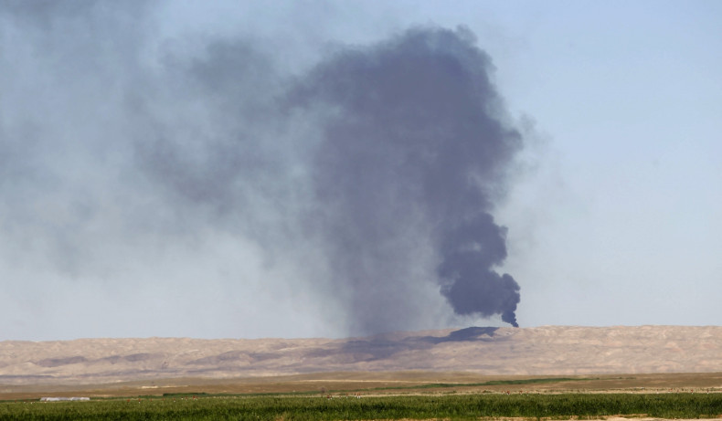 Smoke rises from the Ajil oil field