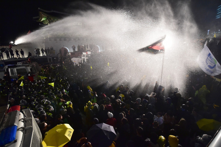 Riot police spray protesters in Seoul