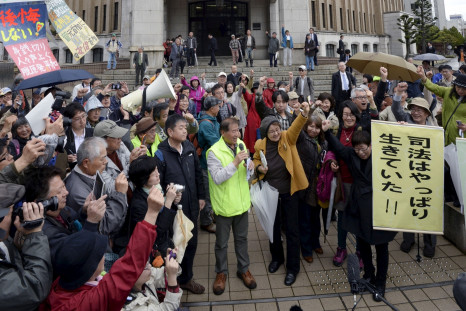 Anti-nuclear protesters cheer outside Fukui District Court