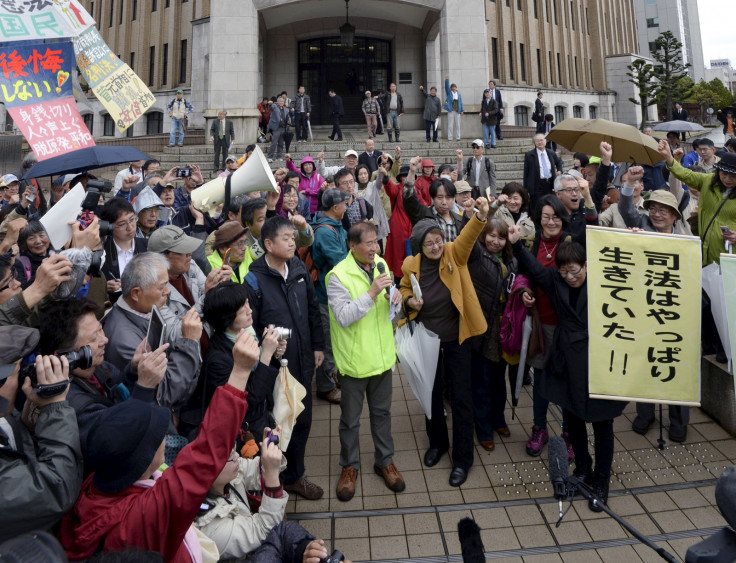 Anti-nuclear protesters cheer outside Fukui District Court