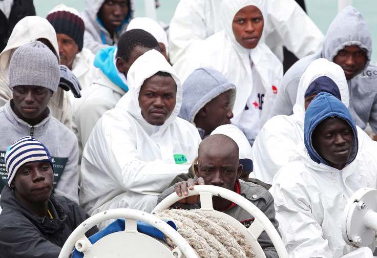 Migrants wait to disembark in Catania