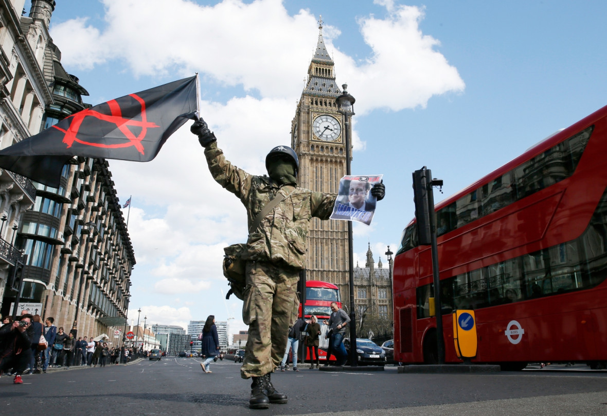 Protestor holds an anarchist flag Protestor holds an anarchist flag