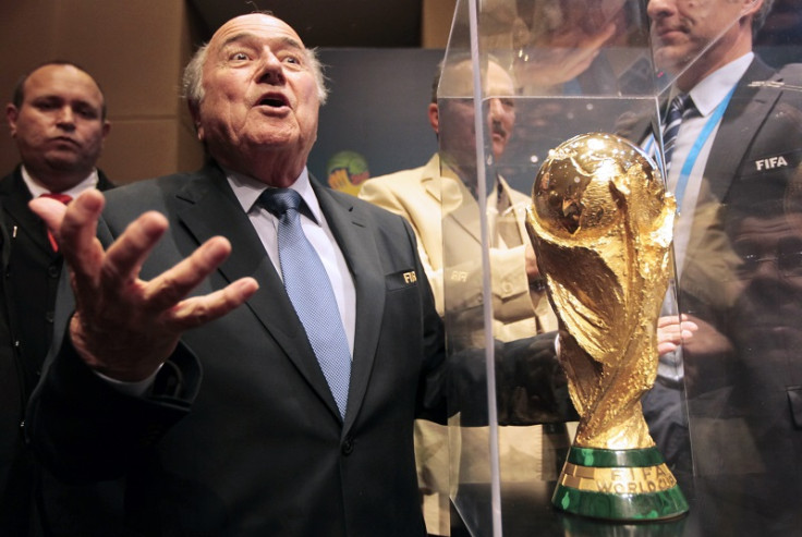 Sepp Blatter gestures World Cup trophy