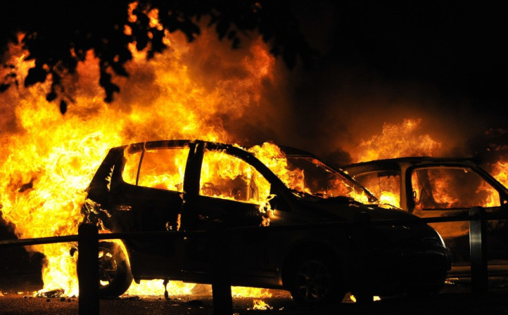 Cars burn on a street in Ealing, London