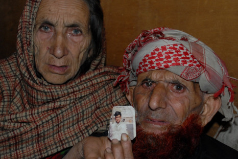 Shafqat Hussai's parents hold up his photo
