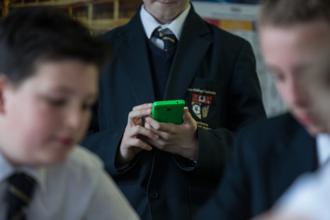 UK schoolboy using smartphone