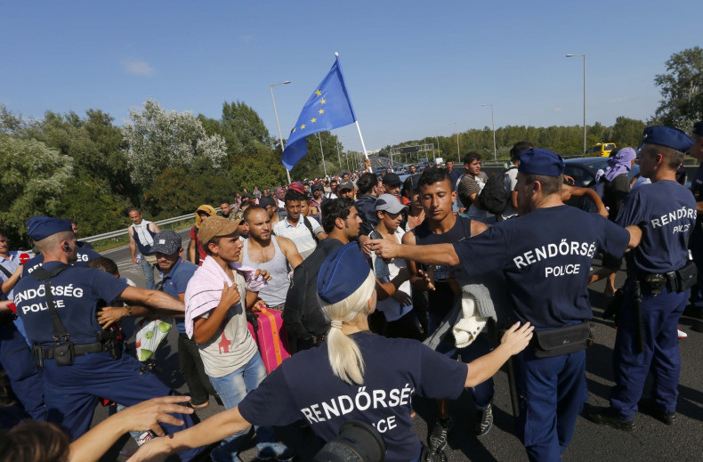 Migrants march along the highway