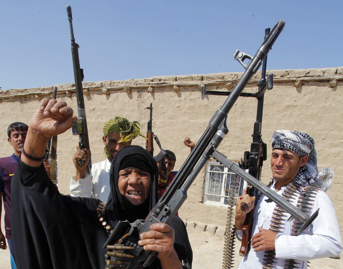 Iraq woman and sons holding guns Iraq woman and sons holding guns
