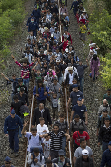 migrants guarded by police migrants guarded by police