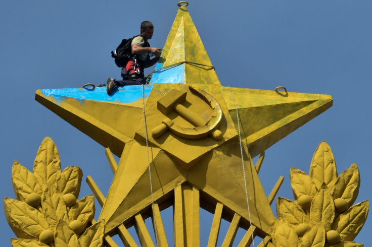 A worker repairs a Soviet star