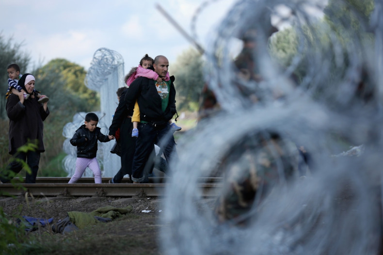 Refugees pass over the Hungarian border
