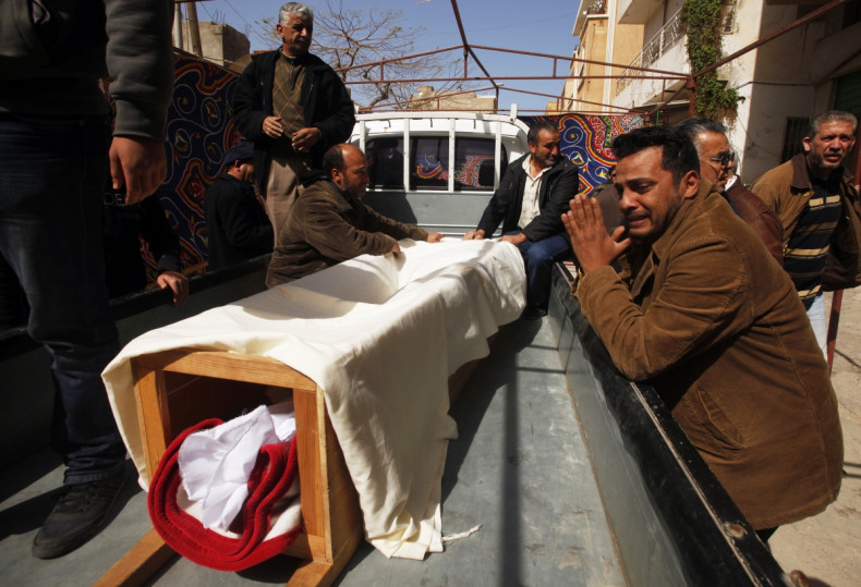 Relative cries next to a coffin
