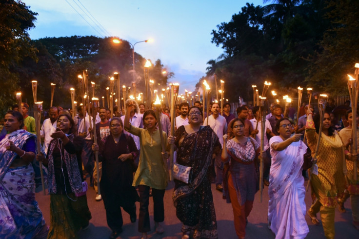 Bangladeshi secular activists take part in a torch-lit protest against the killing of blogger Niloy Chakrabarti, who used the pen-name Niloy Neel, in Dhaka on August