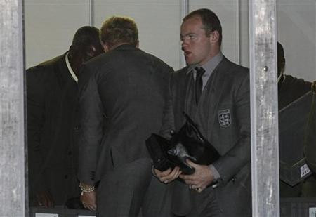 England's Wayne Rooney goes through airport security as the team leaves South Africa at O R Tambo airport in Johannesburg