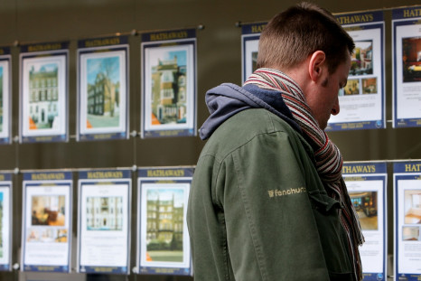 Man looking at estate agent window