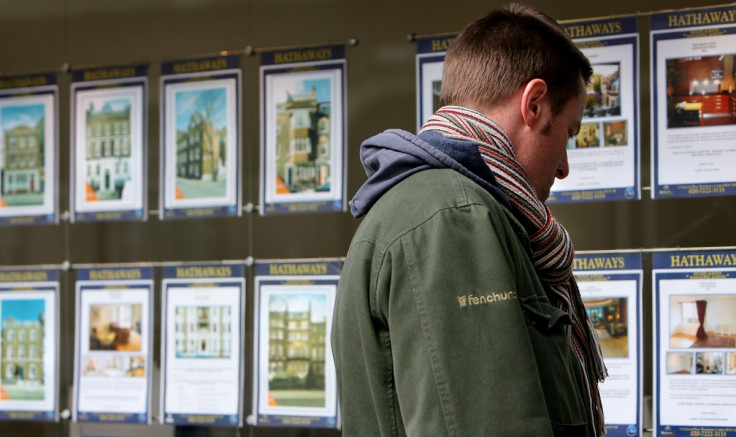 Man looking at estate agent window