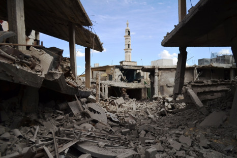 damaged buildings and a minaret in the central Syrian town of Talbisseh in the Homs province