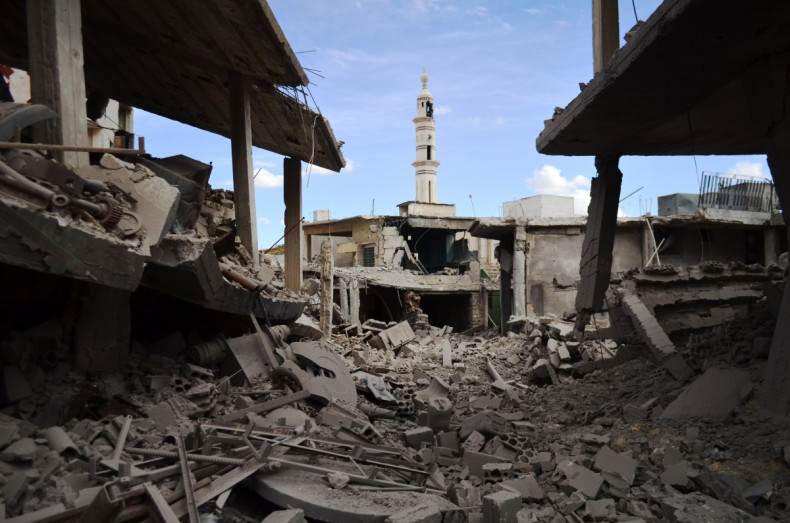 damaged buildings and a minaret in the central Syrian town of Talbisseh in the Homs province