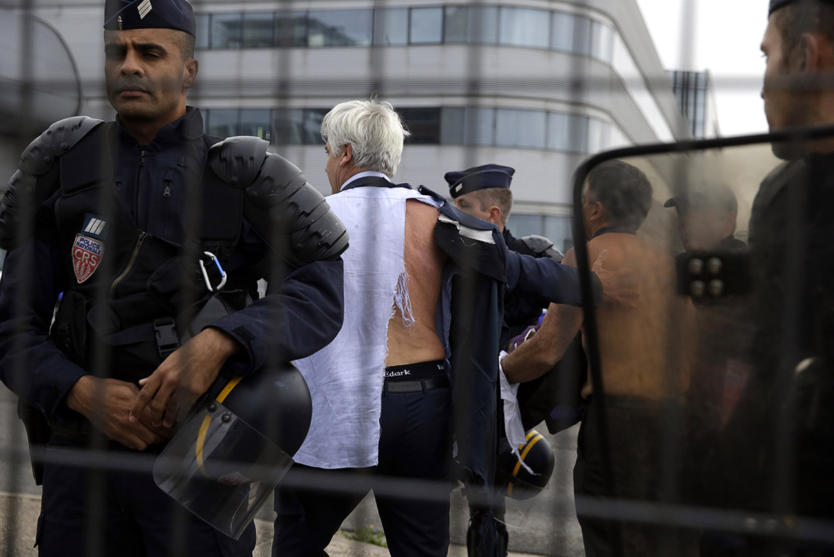 Angry employees of Air France tear off managers shirts 