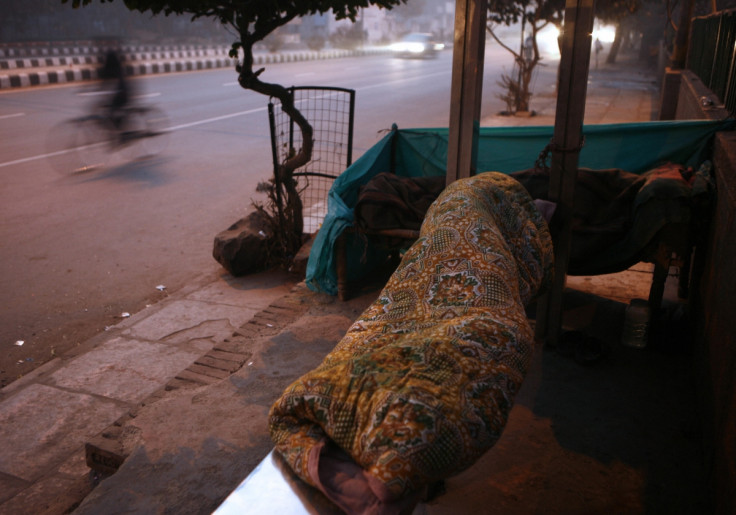 Homeless Indian man at bus stop