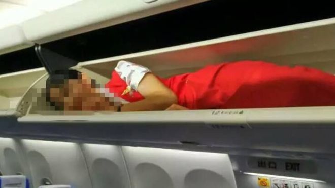 Kunming Airlines crew members overhead lockers China