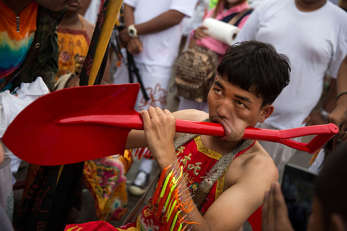 Thailand vegetarian festival: Bizarre facial piercings include guns