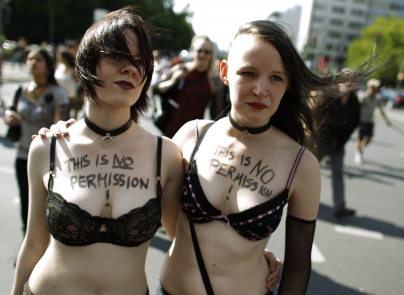 Two women participate in a SlutWalk rally against sexual abuse in central Berlin