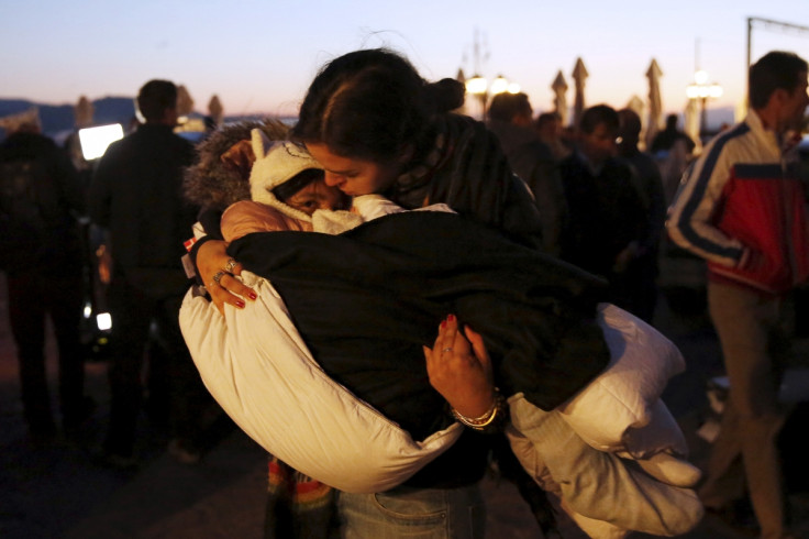 Lesbos volunteer cradles child