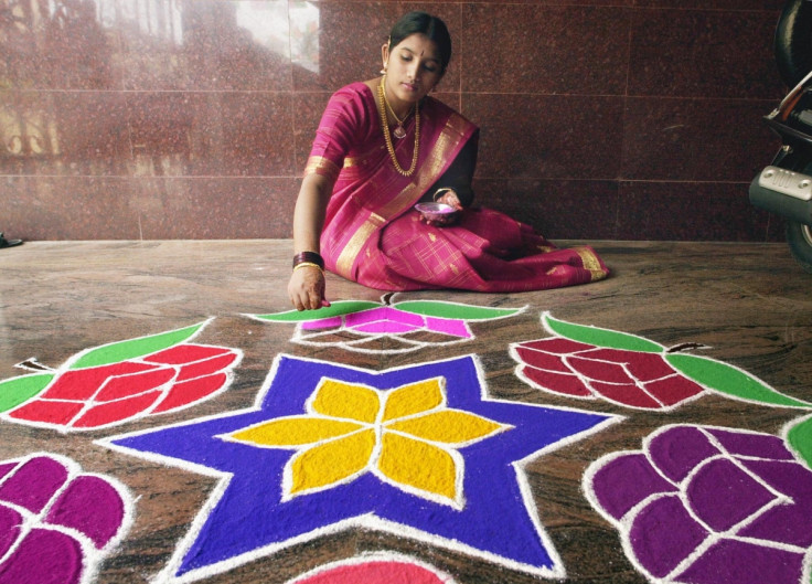 Girl making Rangoli designs in India
