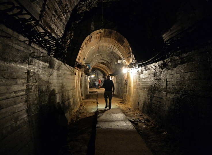 Men walk in underground galleries, part of Nazi Germany 'Riese' construction project under the Ksiaz castle in the area where the 'Nazi gold train' is supposedly hidden underground