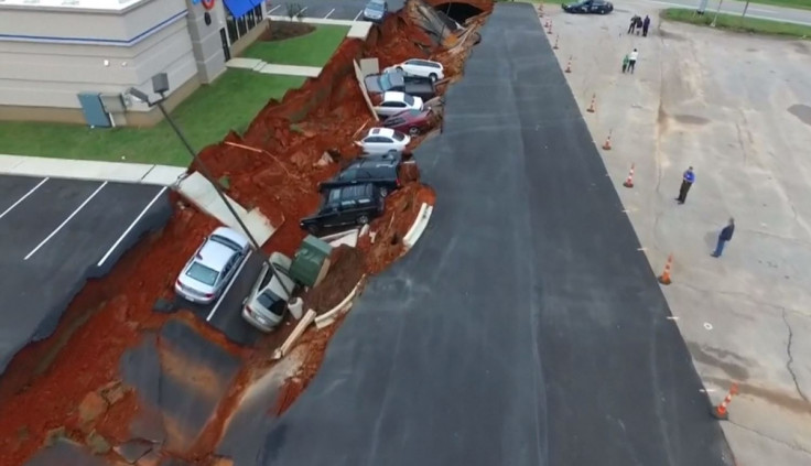 Huge sink hole swallows cars