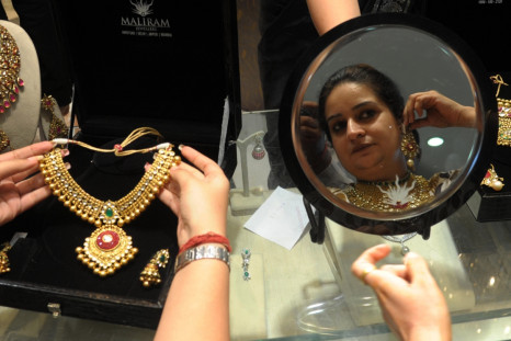 Indian woman tries on gold jewellery