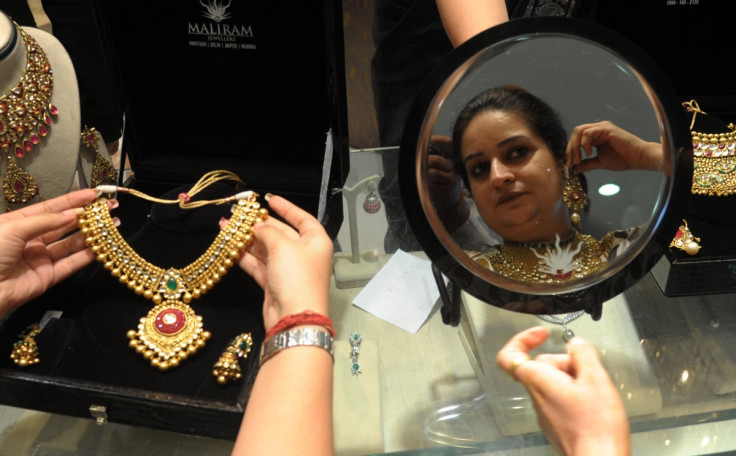 Indian woman tries on gold jewellery