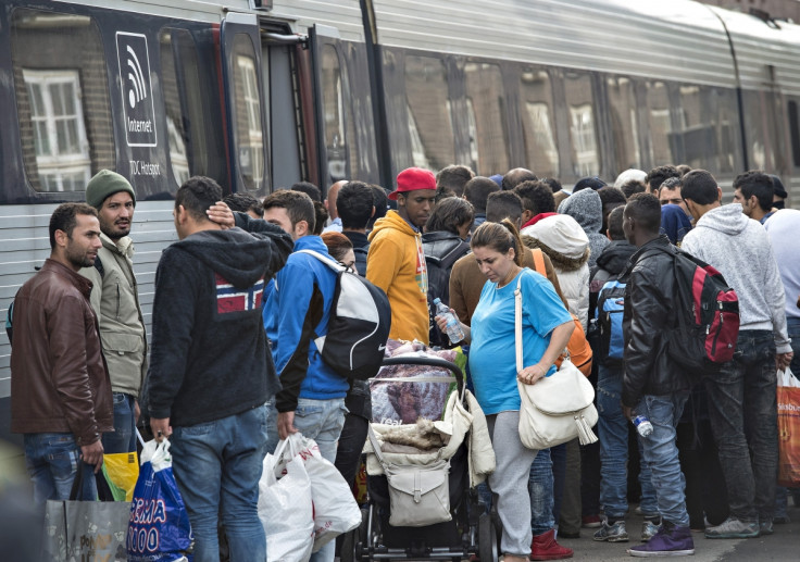 Immigrants board a train bound for Sweden