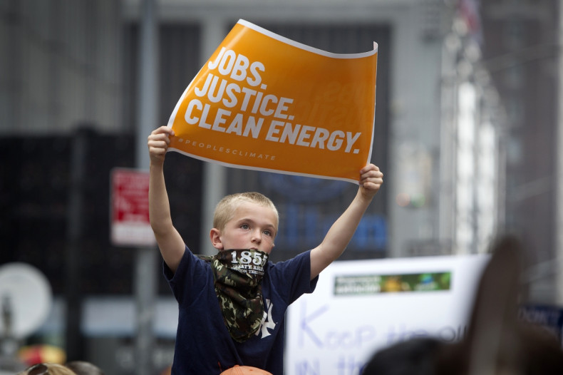 child holds protest sign