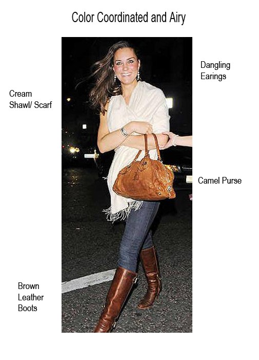 Kate Middleton wearing a cream shawl over jeans and brown boots.