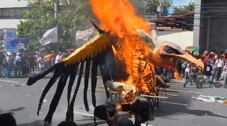 APEC protesters burn vulture effigy 
