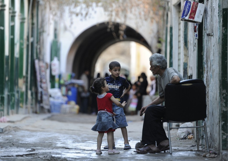 Children play with an old man in the Old City of Tripoli