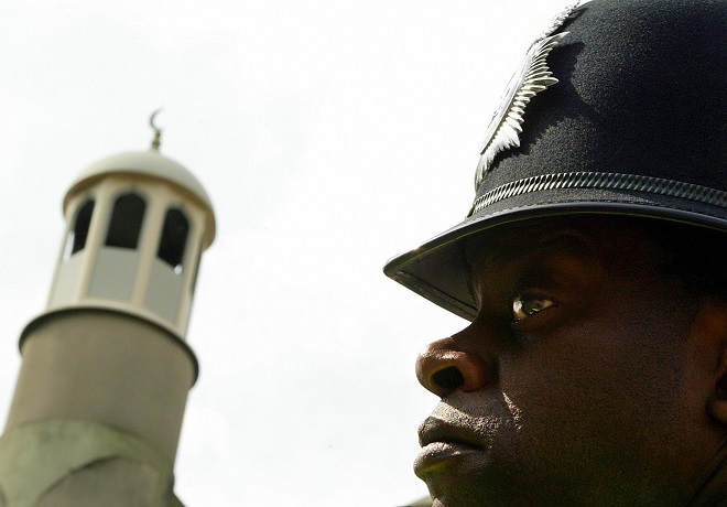 Policeman stands guard outside mosque in London Policeman stands guard outside mosque in London