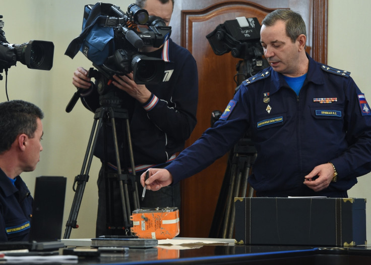 A Russian military official points to the flight recorder from the Russian Sukhoi Su-24 bomber which was shot down by a Turkish jet on November 24