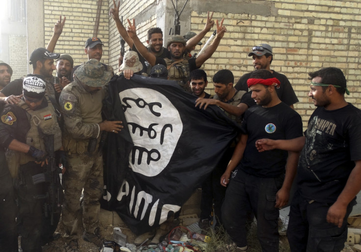 Iraqi soldiers hold ISIS flag in Ramadi